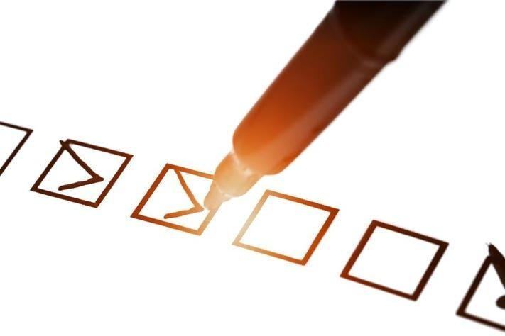 A pen ticking boxes on a checklist